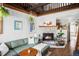 Inviting living room with a stone fireplace, comfortable seating, and warm, natural lighting at 26288 S End Rd, Kittredge, CO 80457