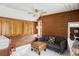 Comfortable living room with wood paneling, built-in cabinets, a cozy couch and a view of the staircase at 26288 S End Rd, Kittredge, CO 80457