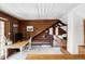 Loft area featuring a desk, wood walls and staircase leading up to a sleeping area at 26288 S End Rd, Kittredge, CO 80457