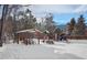 A snow-covered playground with picnic tables and playset surrounded by snow-covered ground at 26288 S End Rd, Kittredge, CO 80457