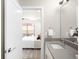 Modern bathroom with single vanity and view into bedroom at 5360 Allison St # D, Arvada, CO 80002
