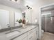 Double vanity bathroom with modern fixtures and a large shower at 5360 Allison St # D, Arvada, CO 80002