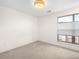 Well-lit bedroom featuring a large window and carpet flooring at 5360 Allison St # D, Arvada, CO 80002