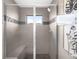 Large walk-in shower with tiled walls and built-in seat at 5360 Allison St # D, Arvada, CO 80002