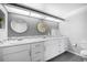 Bright bathroom features double sinks, modern vanity, decorative mirrors, and stylish mosaic tile accents at 14390 E Marina Dr # 606, Aurora, CO 80014