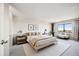 A bright bedroom with a view, a sitting area, and stylish modern furniture for a peaceful retreat at 14390 E Marina Dr # 606, Aurora, CO 80014