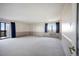 Airy bedroom featuring a sliding glass door to the balcony, wall-to-wall carpeting, and great natural light at 14390 E Marina Dr # 606, Aurora, CO 80014