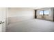 Large bedroom featuring a window with a view, wall-to-wall carpeting, and neutral paint at 14390 E Marina Dr # 606, Aurora, CO 80014