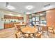 Features a cozy dining area with tables, chairs, and a kitchenette with cabinets at 14390 E Marina Dr # 606, Aurora, CO 80014