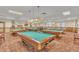 A vibrant game room with multiple pool tables under lit signage, creating a recreational space at 14390 E Marina Dr # 606, Aurora, CO 80014
