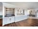 Open concept living room with hardwood floors, a wet bar, and views into the kitchen at 14390 E Marina Dr # 606, Aurora, CO 80014