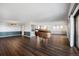 Expansive living room with rich wood floors, piano, and combination bar and buffet at 14390 E Marina Dr # 606, Aurora, CO 80014