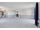 Large living room with new carpet and blue drapes at 14390 E Marina Dr # 606, Aurora, CO 80014