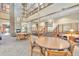 A grand lobby featuring a stone fireplace, comfortable seating, and a staircase to upper levels at 14390 E Marina Dr # 606, Aurora, CO 80014