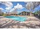 A clear blue swimming pool surrounded by lounging areas and mature trees, inviting relaxation at 14390 E Marina Dr # 606, Aurora, CO 80014