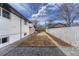 A spacious backyard with a grass area, gravel, mulch, and a fence for privacy at 4001 Wyandot St, Denver, CO 80211