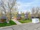 Aerial view of a single Gathering home in Littleton, CO with large trees and green lawn at 4433 S Washington St, Englewood, CO 80113