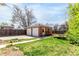 Backyard features a brick detached garage, trampoline, and an open grassy area at 4433 S Washington St, Englewood, CO 80113