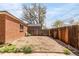 The backyard is fenced and includes a brick home and xeriscaped area at 4433 S Washington St, Englewood, CO 80113