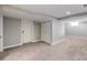 Spacious basement featuring neutral carpet and light gray walls, and closet area at 4433 S Washington St, Englewood, CO 80113