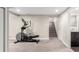 Spacious basement with neutral carpet and an elliptical machine for workouts at 4433 S Washington St, Englewood, CO 80113