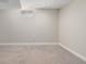 Clean basement area with neutral carpet, bright lighting, and a small window at 4433 S Washington St, Englewood, CO 80113