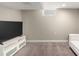 Finished basement with neutral carpet, big screen television, and a built-in entertainment unit at 4433 S Washington St, Englewood, CO 80113