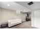 Finished basement with a white couch and an elliptical machine for easy workouts at 4433 S Washington St, Englewood, CO 80113