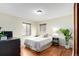 Bedroom featuring hardwood floors, two windows and a ceiling light at 4433 S Washington St, Englewood, CO 80113