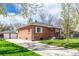Charming brick home with a well-manicured lawn and a detached two-car garage, offering both curb appeal and practicality at 4433 S Washington St, Englewood, CO 80113
