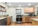 Bright kitchen featuring granite countertops, stainless steel appliances and hardwood flooring at 4433 S Washington St, Englewood, CO 80113