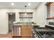 Kitchen featuring a stainless steel dishwasher, updated granite countertops and wood cabinets at 4433 S Washington St, Englewood, CO 80113