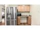 Kitchen with stainless steel refrigerator, coffee bar and wood cabinets at 4433 S Washington St, Englewood, CO 80113