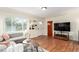 Bright living room with hardwood floors, large window, and comfortable gray sofa at 4433 S Washington St, Englewood, CO 80113
