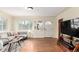 Bright living room with hardwood floors, large window, and comfortable gray sofa at 4433 S Washington St, Englewood, CO 80113