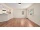 Open-concept living space with hardwood flooring, a kitchen view, and abundant natural light at 4433 S Washington St, Englewood, CO 80113