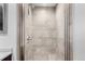Bathroom shower with stone-look tile at 4433 S Washington St, Englewood, CO 80113