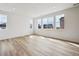 Bright bedroom with ample natural light from multiple windows and featuring sleek, modern flooring at 45952 Gentry Ave, Bennett, CO 80102