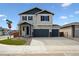 Charming two-story home showcasing a three-car garage and well-manicured landscaping with a spacious driveway at 45952 Gentry Ave, Bennett, CO 80102