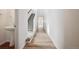 Bright hallway featuring wood floors, staircase and neutral walls, creating a seamless transition throughout the home at 45952 Gentry Ave, Bennett, CO 80102