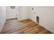 Well-lit laundry room with modern wood-look floors and convenient utility connections at 45952 Gentry Ave, Bennett, CO 80102
