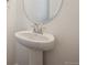 Close-up view of a stylish powder room sink and mirror, complemented by elegant fixtures and neutral walls at 45952 Gentry Ave, Bennett, CO 80102