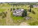 Aerial shot of an expansive property with lush landscaping, a fenced yard, and outdoor living spaces at 3973 Palmer Ridge Dr, Parker, CO 80134