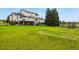 Expansive, well-maintained backyard with a view of the home's back, including multiple decks and outdoor seating at 3973 Palmer Ridge Dr, Parker, CO 80134