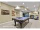 Spacious basement game room includes a billiards table and comfortable seating area for entertainment at 3973 Palmer Ridge Dr, Parker, CO 80134