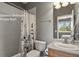 En-suite upstairs bathroom with vanity, white-tiled shower-tub, and natural lighting at 3973 Palmer Ridge Dr, Parker, CO 80134