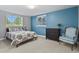Bedroom featuring a bed, dresser, chair, and two windows for lots of natural light at 3973 Palmer Ridge Dr, Parker, CO 80134