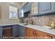 Butler's Pantry with beautiful counter tops and custom cabinets for storage at 3973 Palmer Ridge Dr, Parker, CO 80134