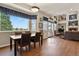 Bright dining area with hardwood floors, large windows, and seamless flow to the living room at 3973 Palmer Ridge Dr, Parker, CO 80134