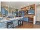 Modern kitchen featuring custom blue cabinetry, a large island, and stainless steel appliances at 3973 Palmer Ridge Dr, Parker, CO 80134